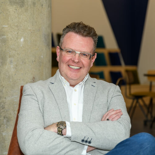 headshot of richard hill ceo and founder of ecomone with arms crossed