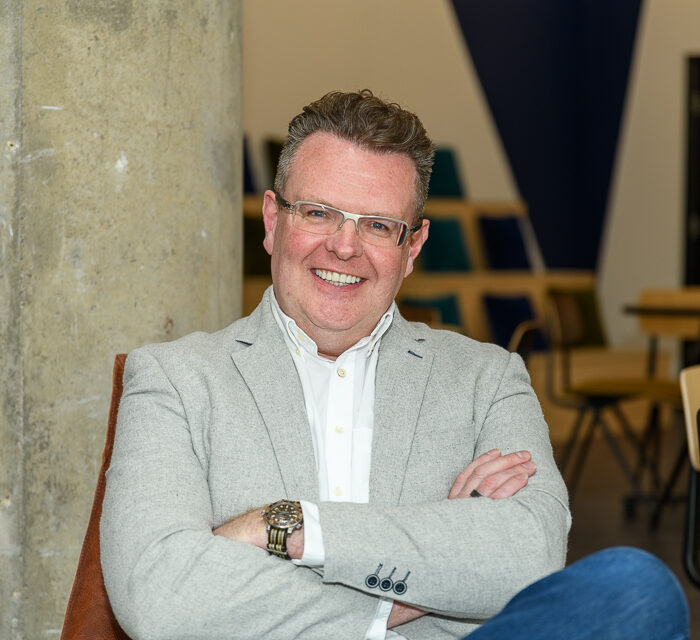 headshot of richard hill ceo and founder of ecomone with arms crossed