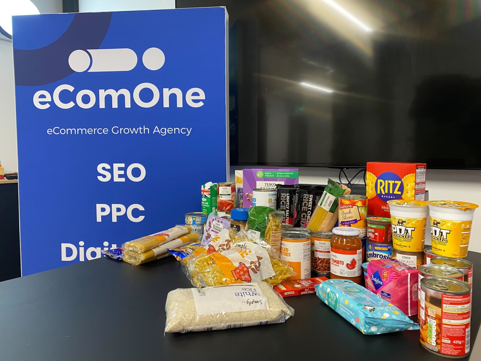 a range of food to be donated on a table in ecomone office